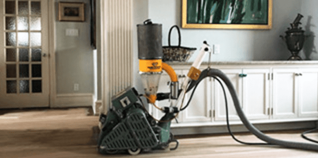 Dustless floor sanding machine in use.