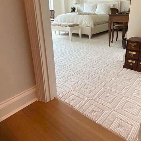 Luxury carpet next to refinished wood floor.