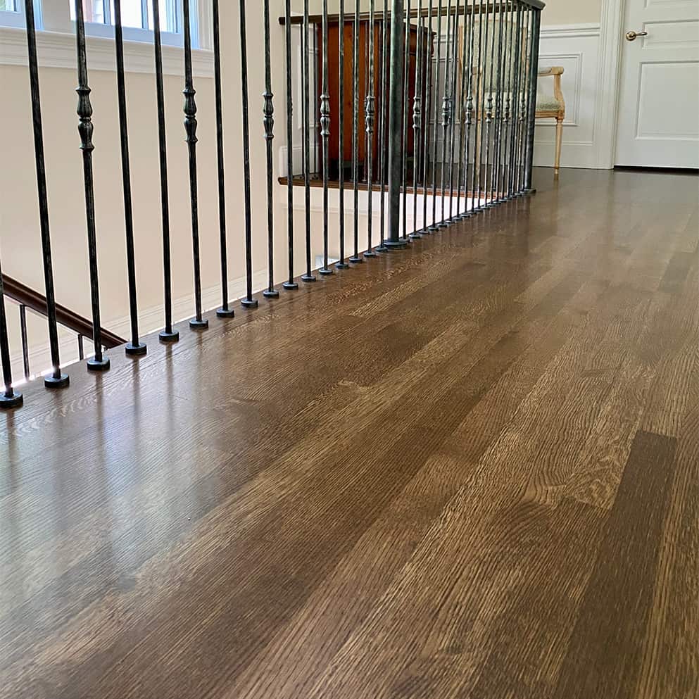 Stairs and upstairs hallway refinished in Wellesley, MA.