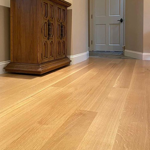 Light hardwood dining room floor stained and finished.