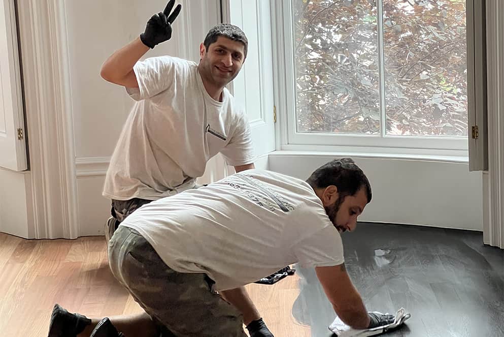 Skilled and friendly team applying custom stain.