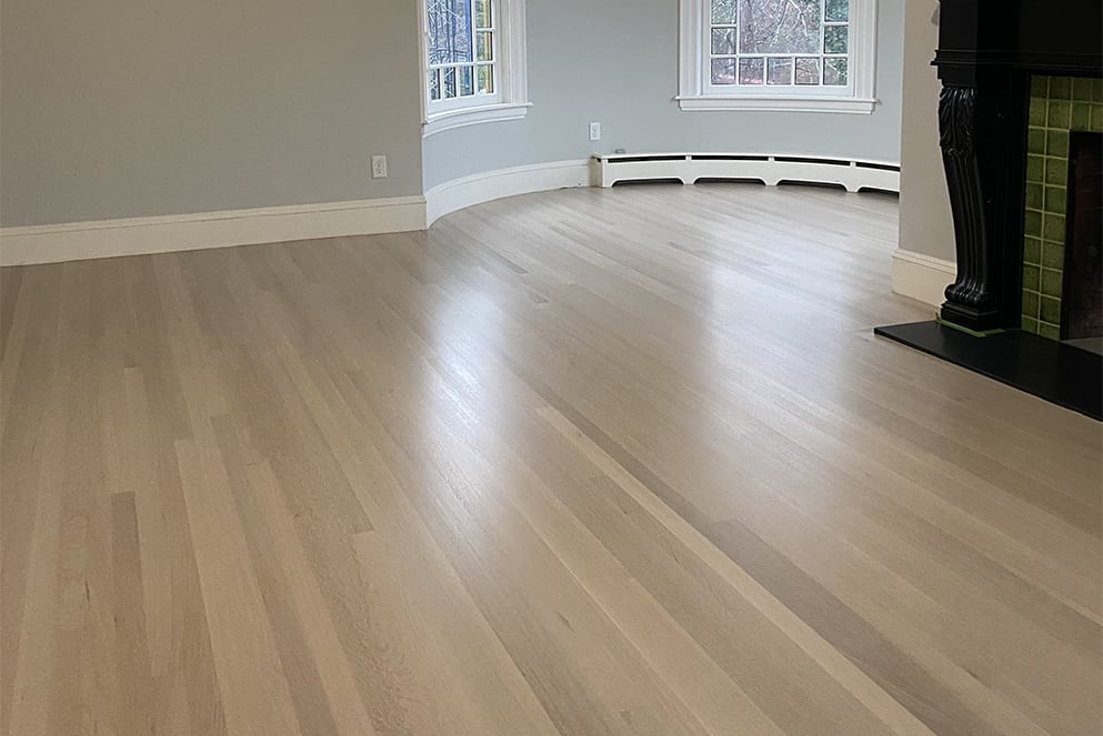 Harwood flooring installed in a complex room and finished.